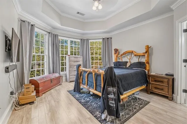 a bathroom with a granite countertop sink a large mirror and a bathtub next to a window