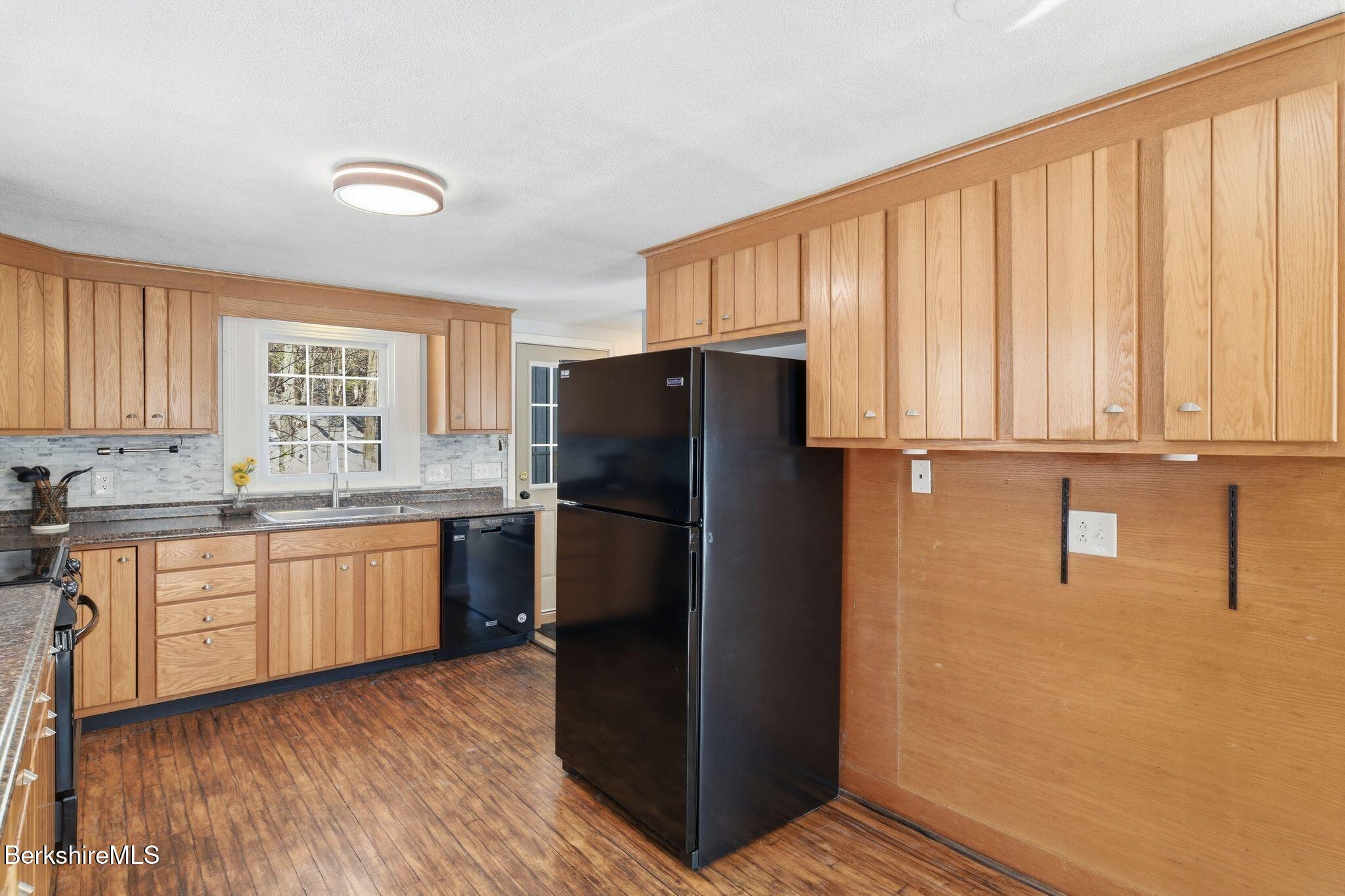 30 Gore Road Blandford, MA 01008 - Photo 17 of 61 a kitchen with granite countertop a refrigerator and cabinets