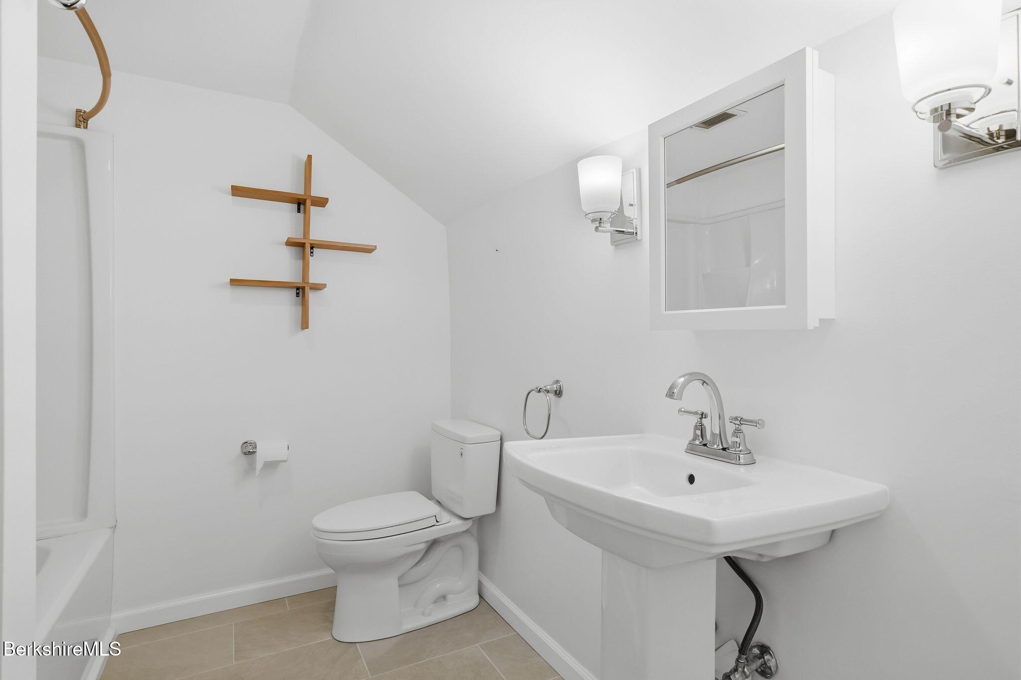 30 Gore Road Blandford, MA 01008 - Photo 38 of 61 a bathroom with a toilet a sink and mirror