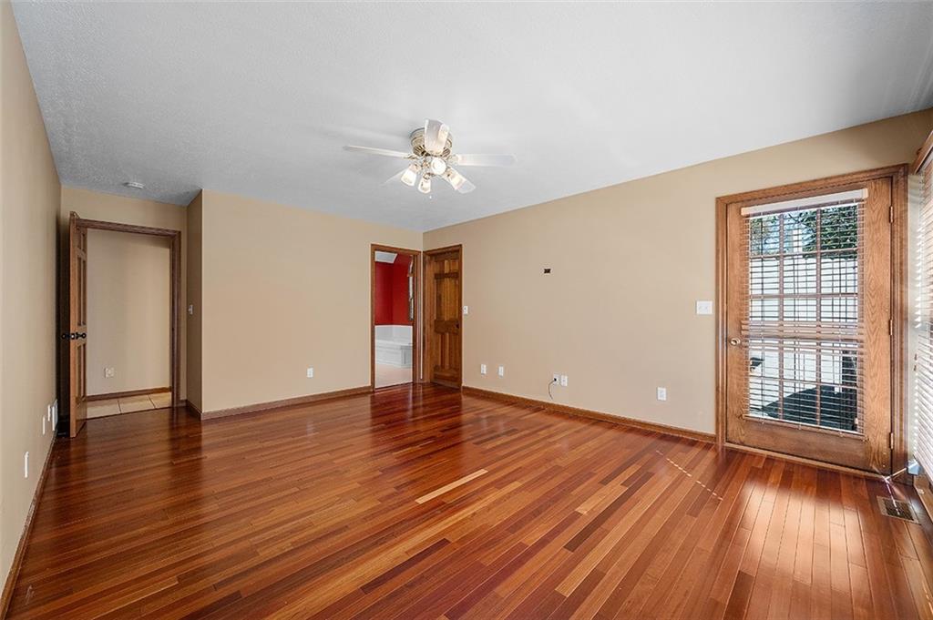 409 Bryn Court Pittsburgh, PA 15237 - Photo 18 of 50 a view of an empty room with wooden floor and a window