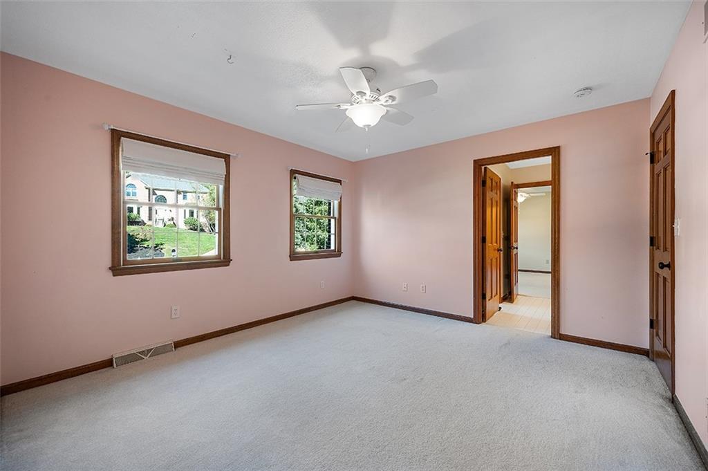 409 Bryn Court Pittsburgh, PA 15237 - Photo 25 of 50 an empty room with windows and chandelier fan