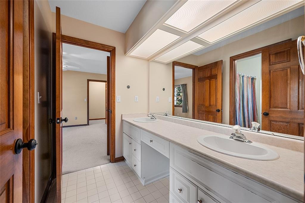 409 Bryn Court Pittsburgh, PA 15237 - Photo 26 of 50 a bathroom with a double vanity sink and a mirror