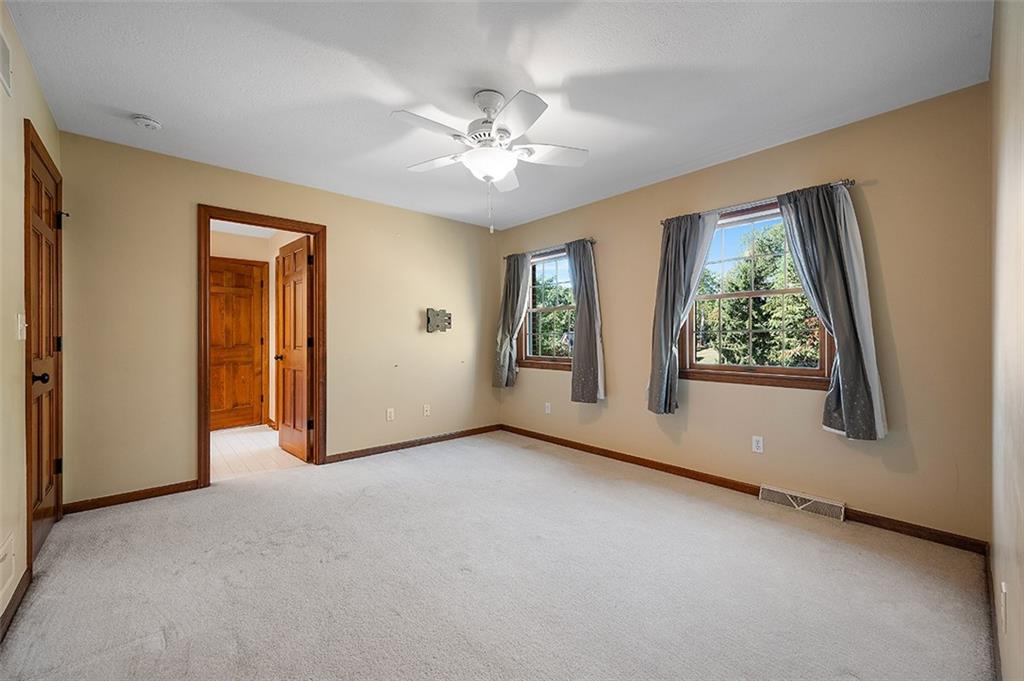 409 Bryn Court Pittsburgh, PA 15237 - Photo 27 of 50 an empty room with windows and chandelier fan