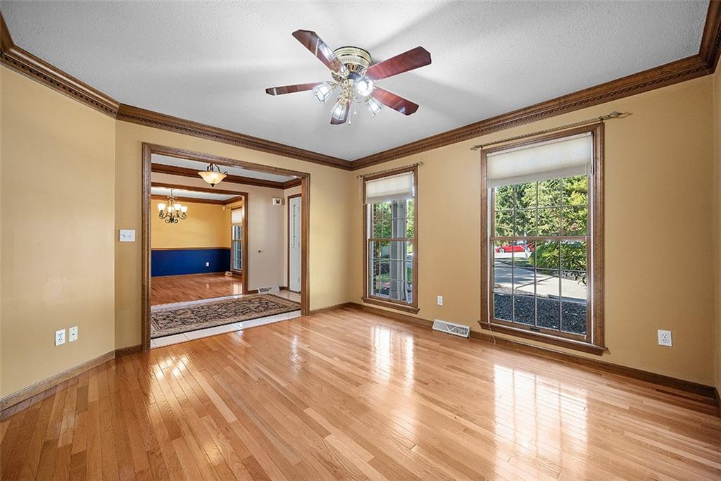 409 Bryn Court Pittsburgh, PA 15237 - Photo 3 of 50 a view of an empty room with wooden floor and a window