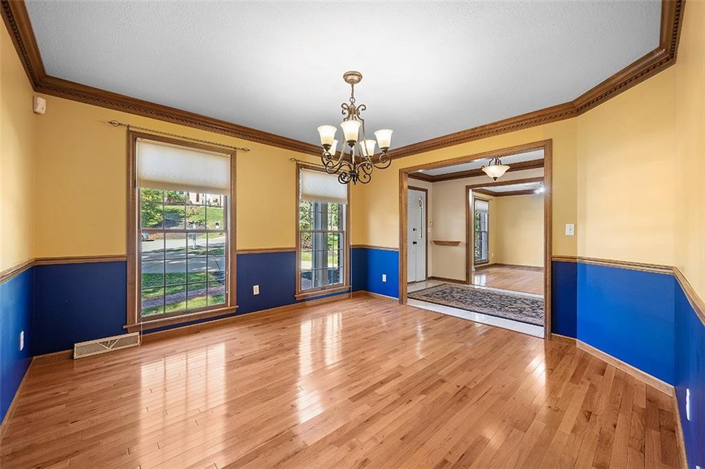 409 Bryn Court Pittsburgh, PA 15237 - Photo 4 of 50 a view of an empty room with window and wooden floor