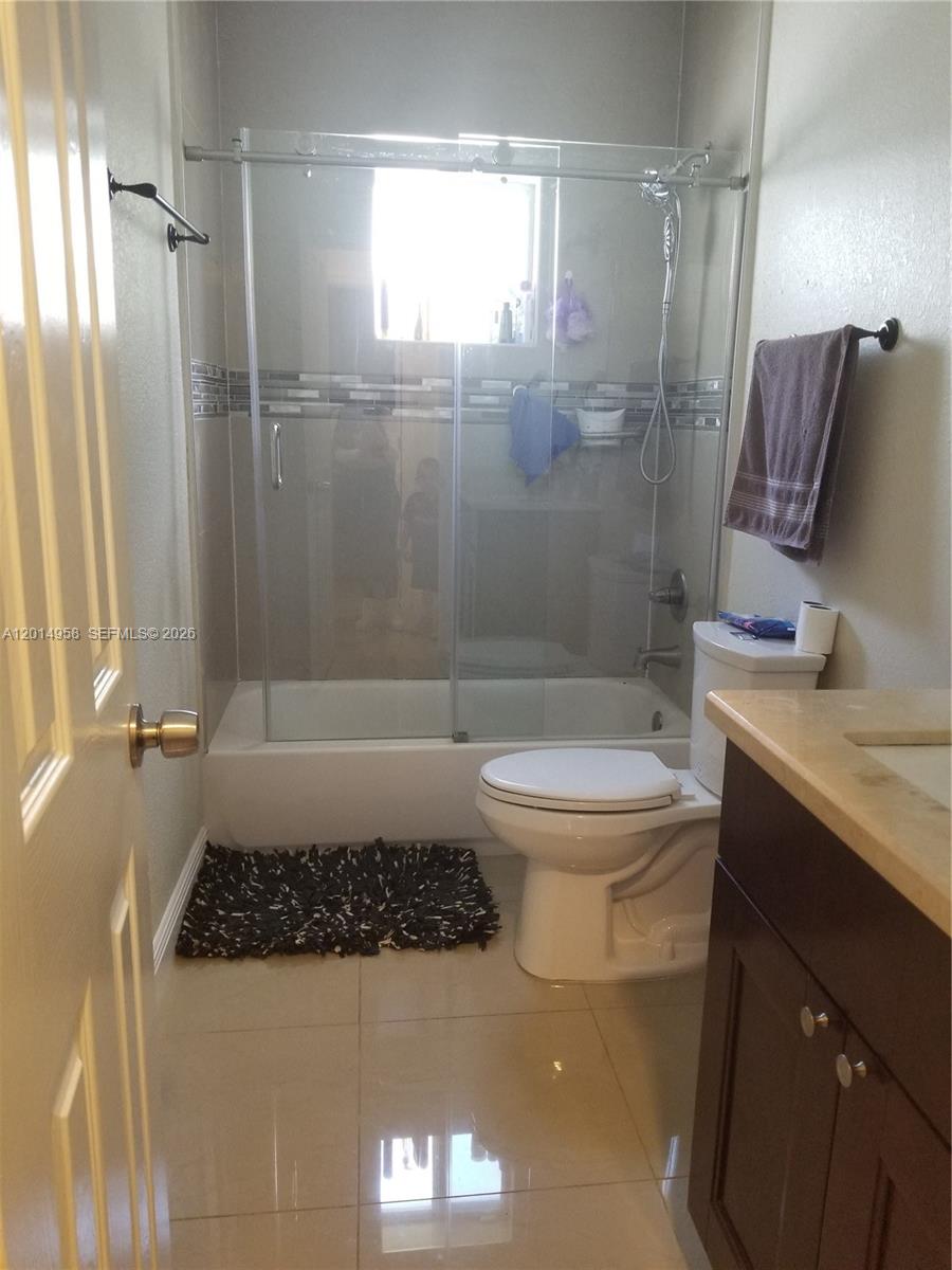 1935 Northwest 96th Street Miami, FL 33147 - Photo 5 of 7 a bathroom with a sink a toilet a mirror and shower