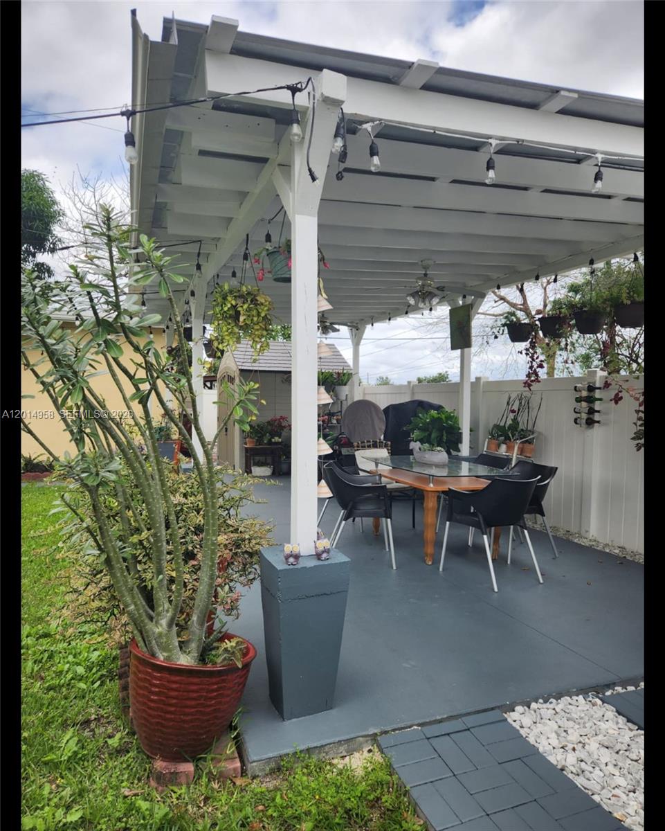 1935 Northwest 96th Street Miami, FL 33147 - Photo 7 of 7 a view of a patio with table and chairs potted plants
