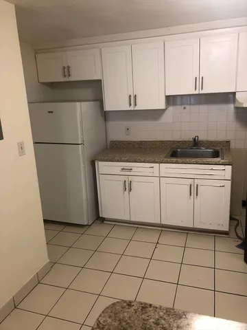 a kitchen with cabinets and white appliances