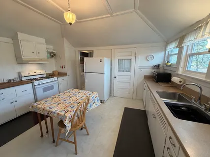 a kitchen with a stove a sink and a refrigerator