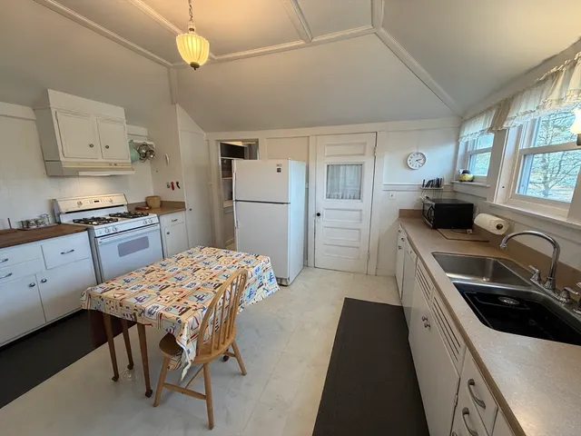 a kitchen with a stove a sink and a refrigerator