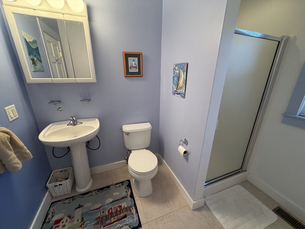 630 Washington Street, Unit 1 Gloucester, MA 01930 - Photo 22 of 28 a bathroom with a sink toilet and a mirror