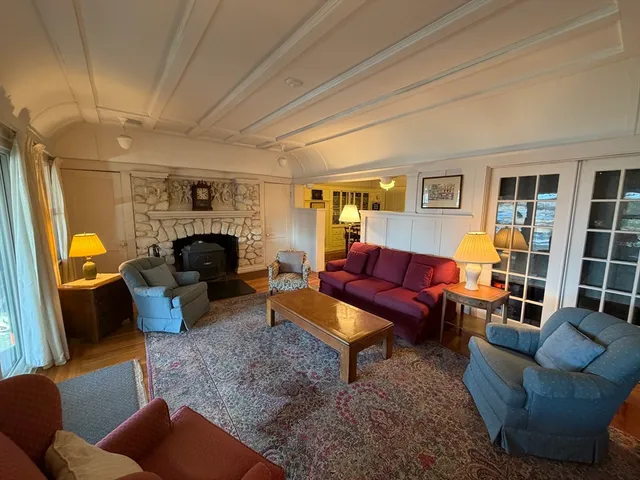 a living room with furniture fireplace and a window