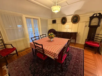 a dining room with a table and chairs