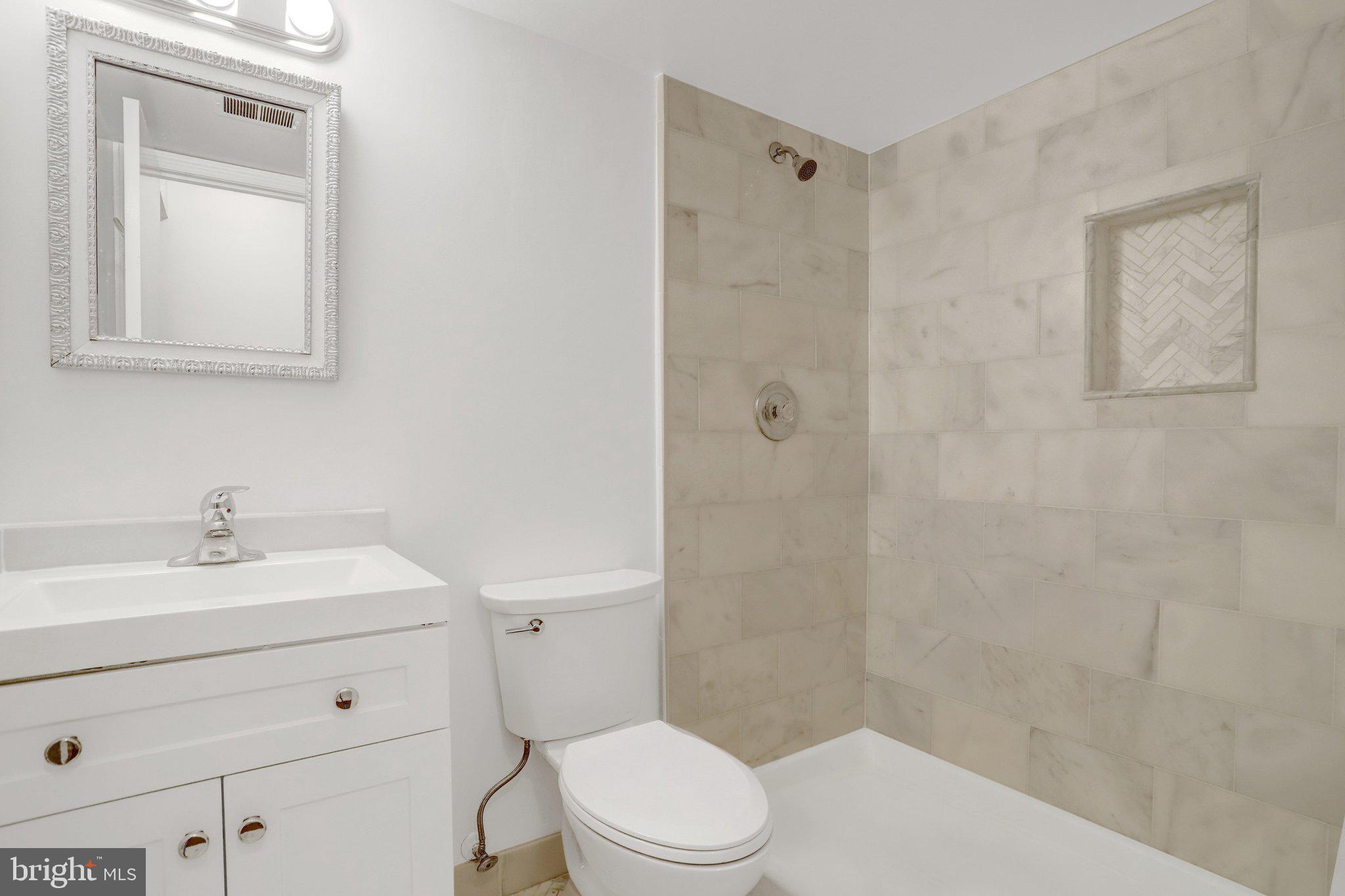 2225 North Tuckahoe Street Arlington, VA 22205 - Photo 26 of 37 a bathroom with a sink a toilet and shower