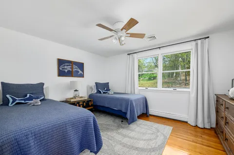 a bedroom with two beds and a window