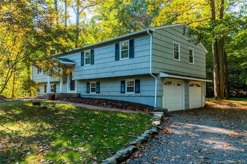 4 Possum Ridge Road Newtown, CT 06470 - Photo 1 of 1 a front view of a house with a garden