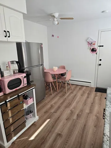 a work room with furniture a rug and a wooden floor