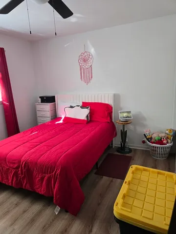 a bedroom with a bed and a chair