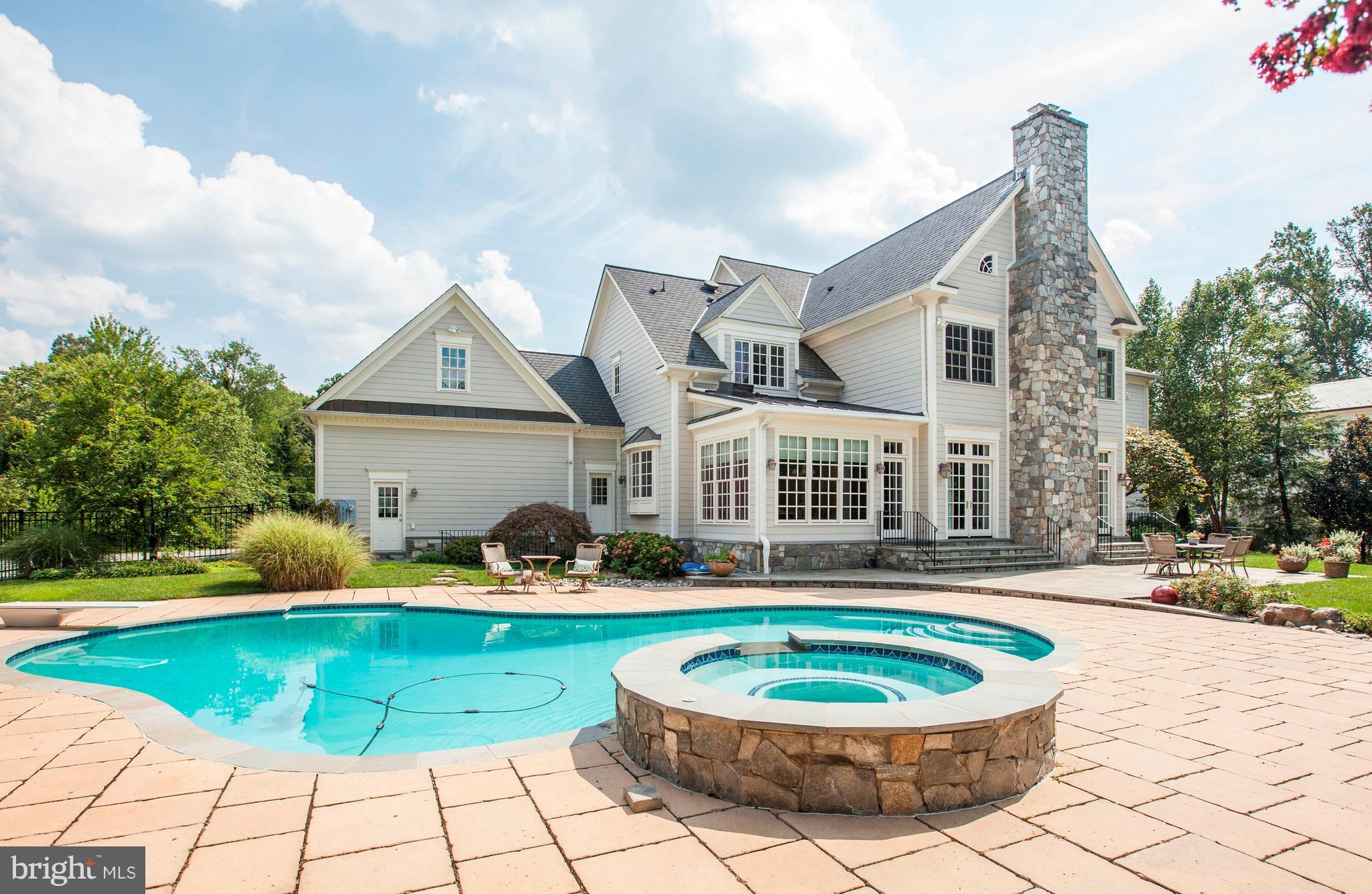 9809 Newhall Road Potomac, MD 20854 - Photo 2 of 37 a view of a house with a backyard and sitting area