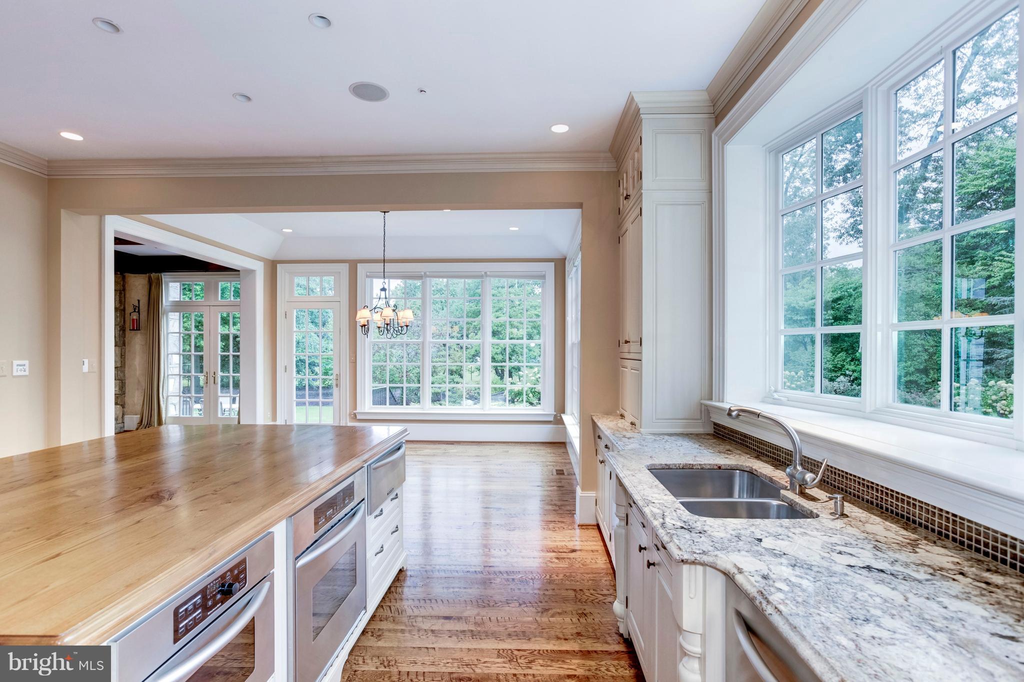 9809 Newhall Road Potomac, MD 20854 - Photo 11 of 37 a kitchen with granite countertop a sink and a stove