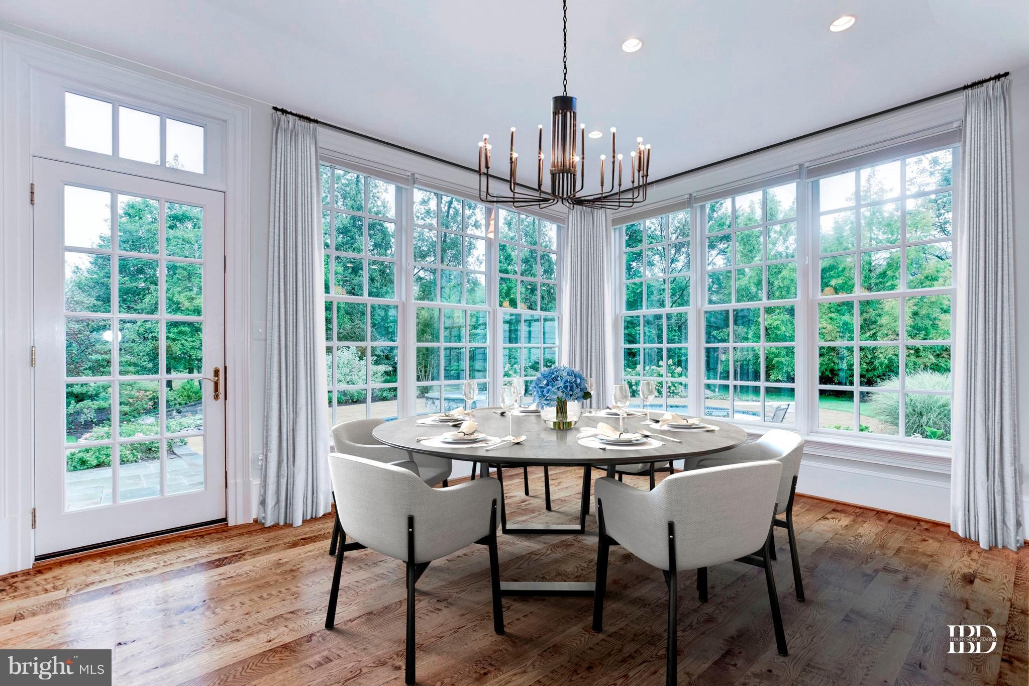 9809 Newhall Road Potomac, MD 20854 - Photo 12 of 37 a view of a dining room with furniture wooden floor and chandelier