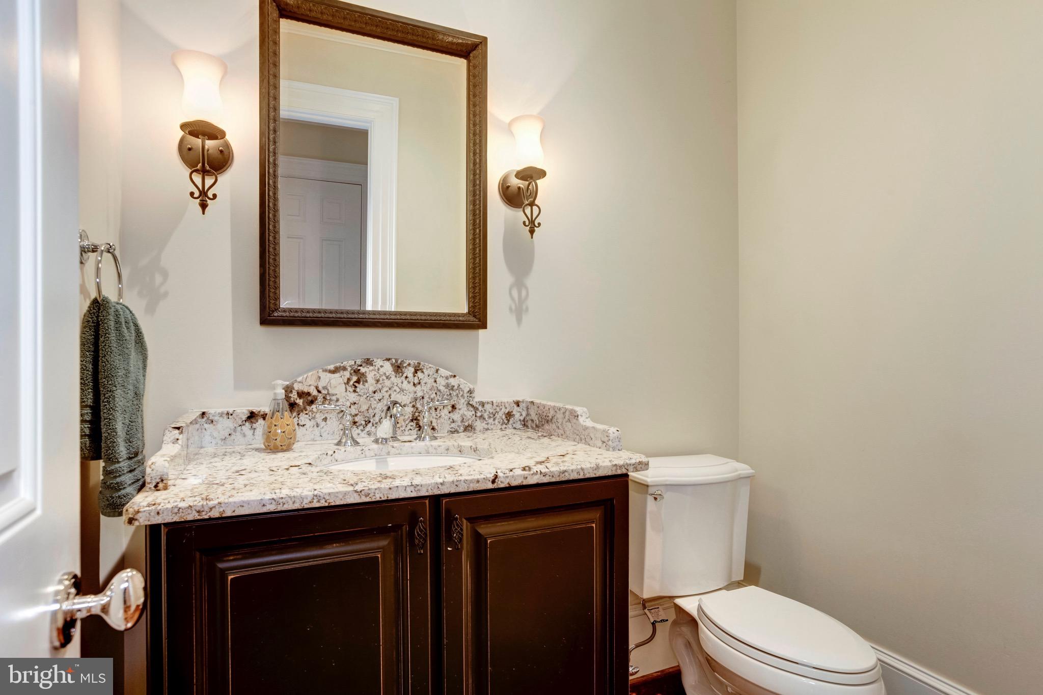 9809 Newhall Road Potomac, MD 20854 - Photo 14 of 37 a bathroom with a sink vanity mirror and toilet