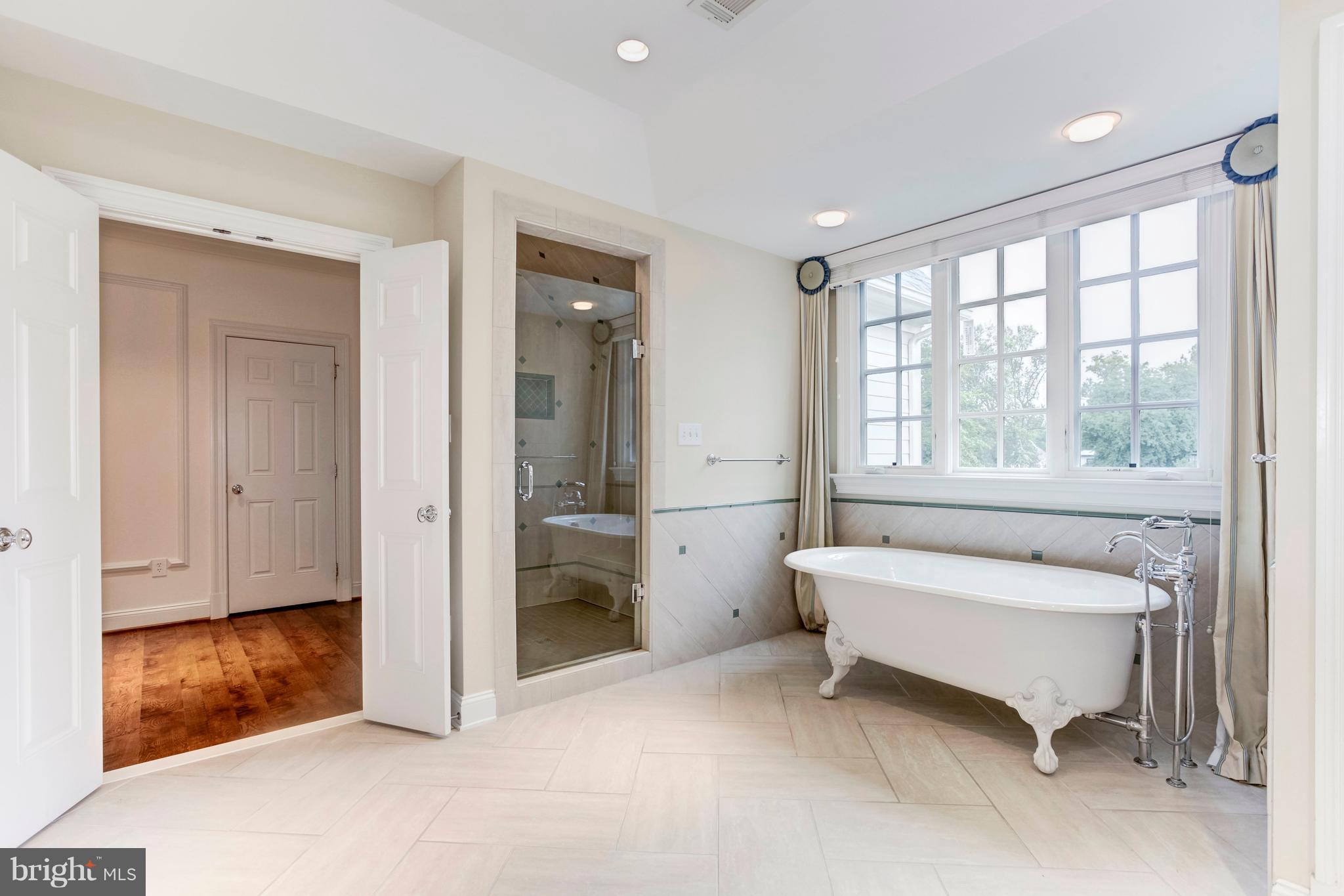 9809 Newhall Road Potomac, MD 20854 - Photo 18 of 37 a spacious bedroom with a bed and a window