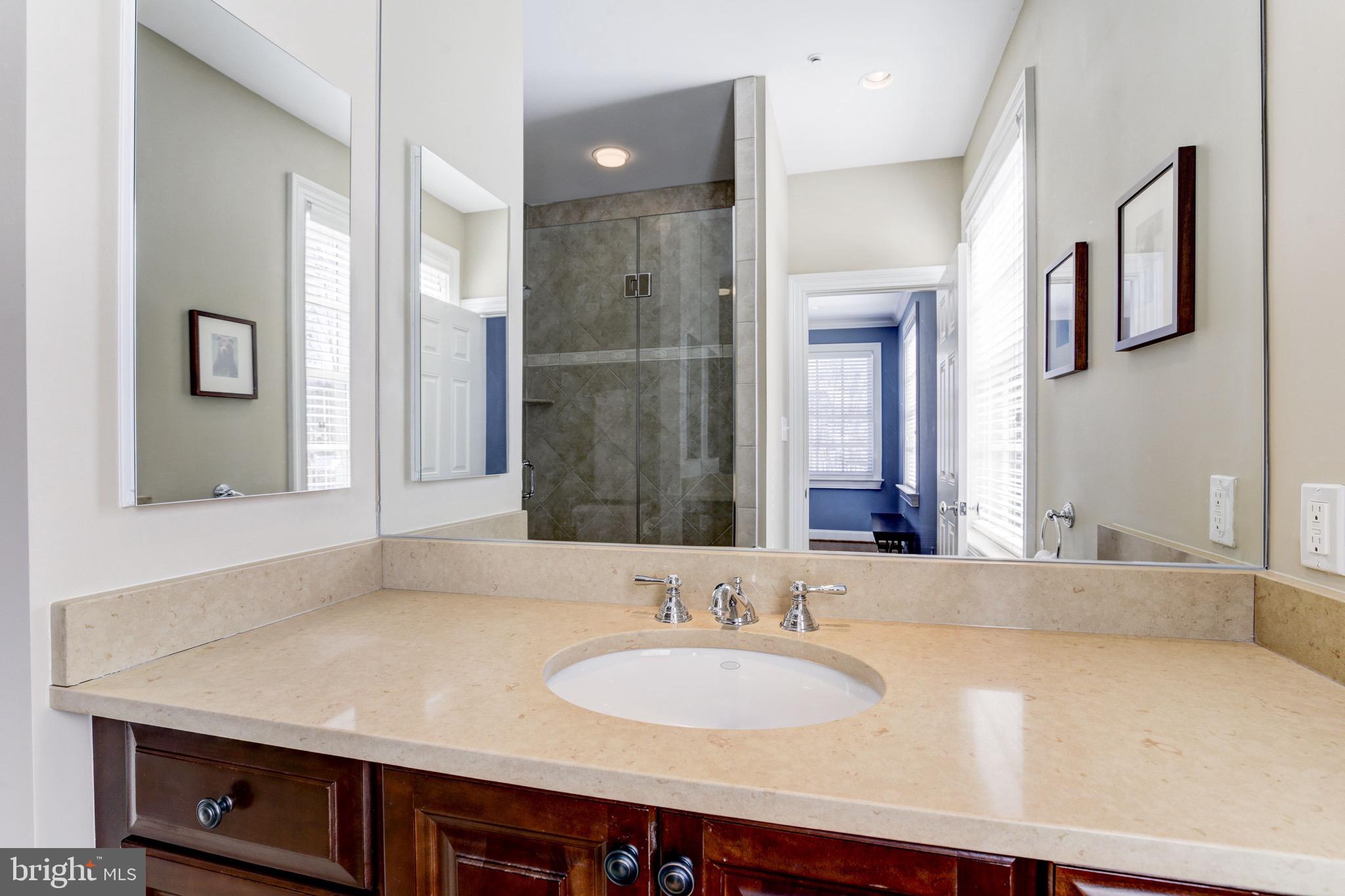 9809 Newhall Road Potomac, MD 20854 - Photo 24 of 37 a bathroom with a granite countertop sink and a mirror