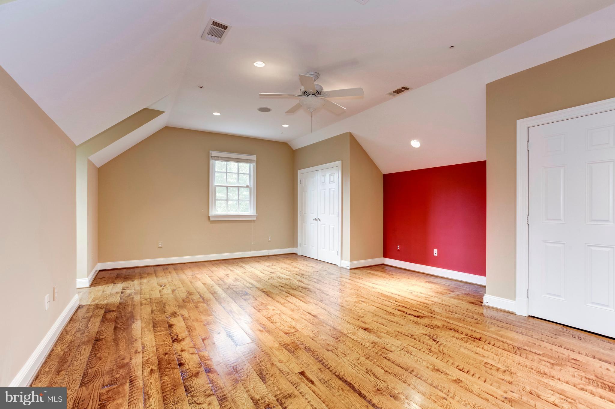 9809 Newhall Road Potomac, MD 20854 - Photo 27 of 37 a view of an empty room with window and wooden floor