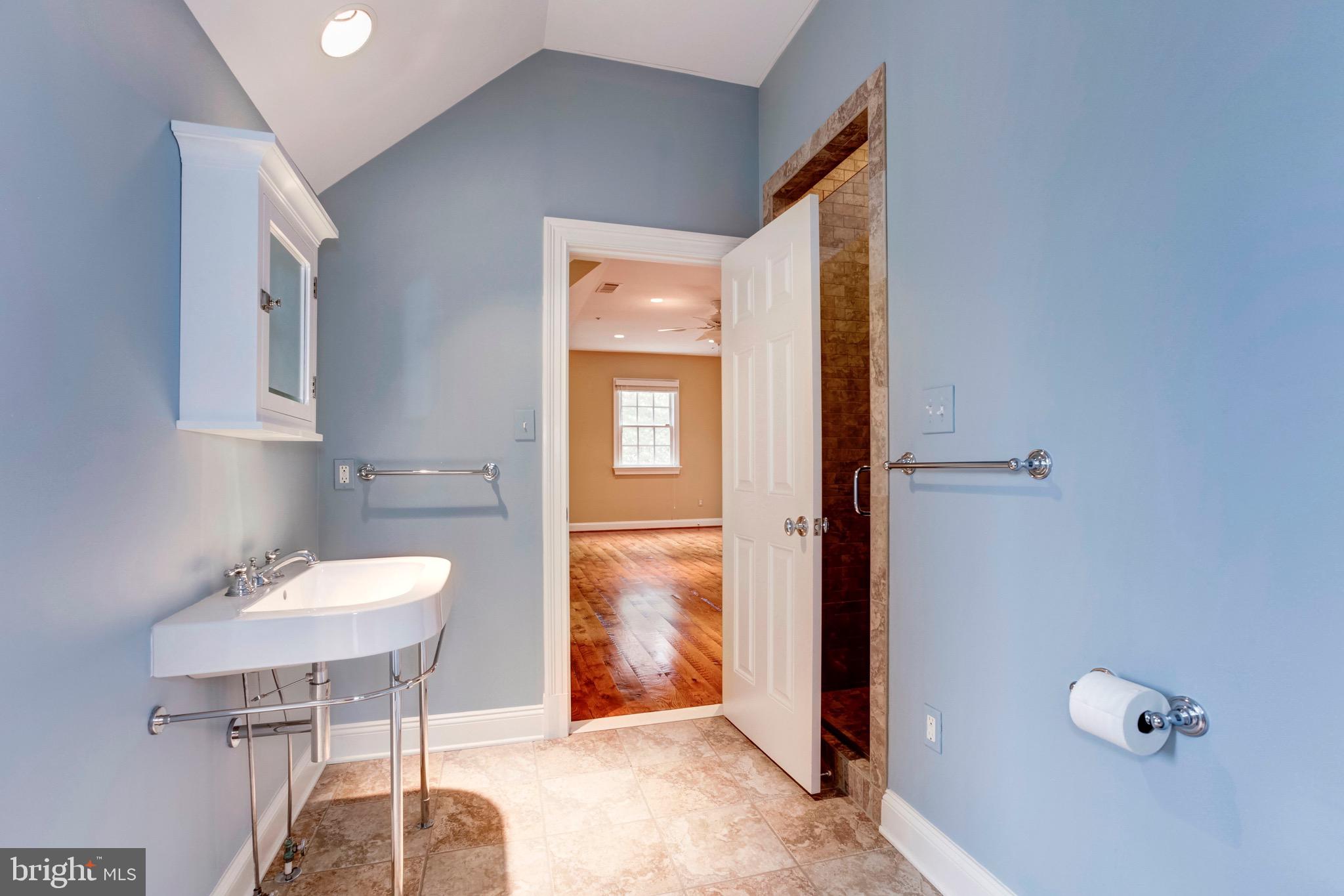 9809 Newhall Road Potomac, MD 20854 - Photo 28 of 37 a bathroom with a sink and a mirror