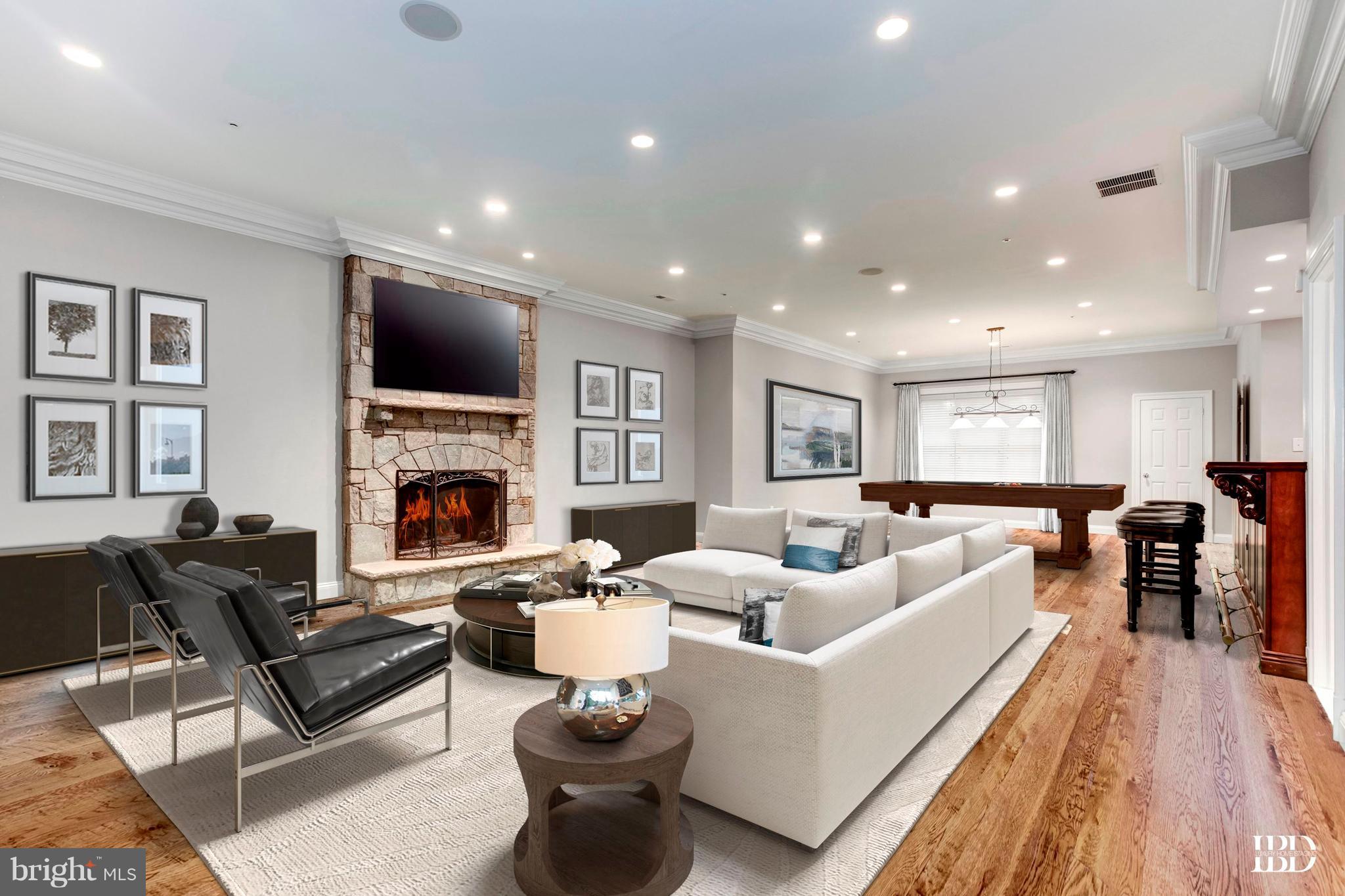 9809 Newhall Road Potomac, MD 20854 - Photo 32 of 37 a living room with furniture a fireplace and a flat screen tv