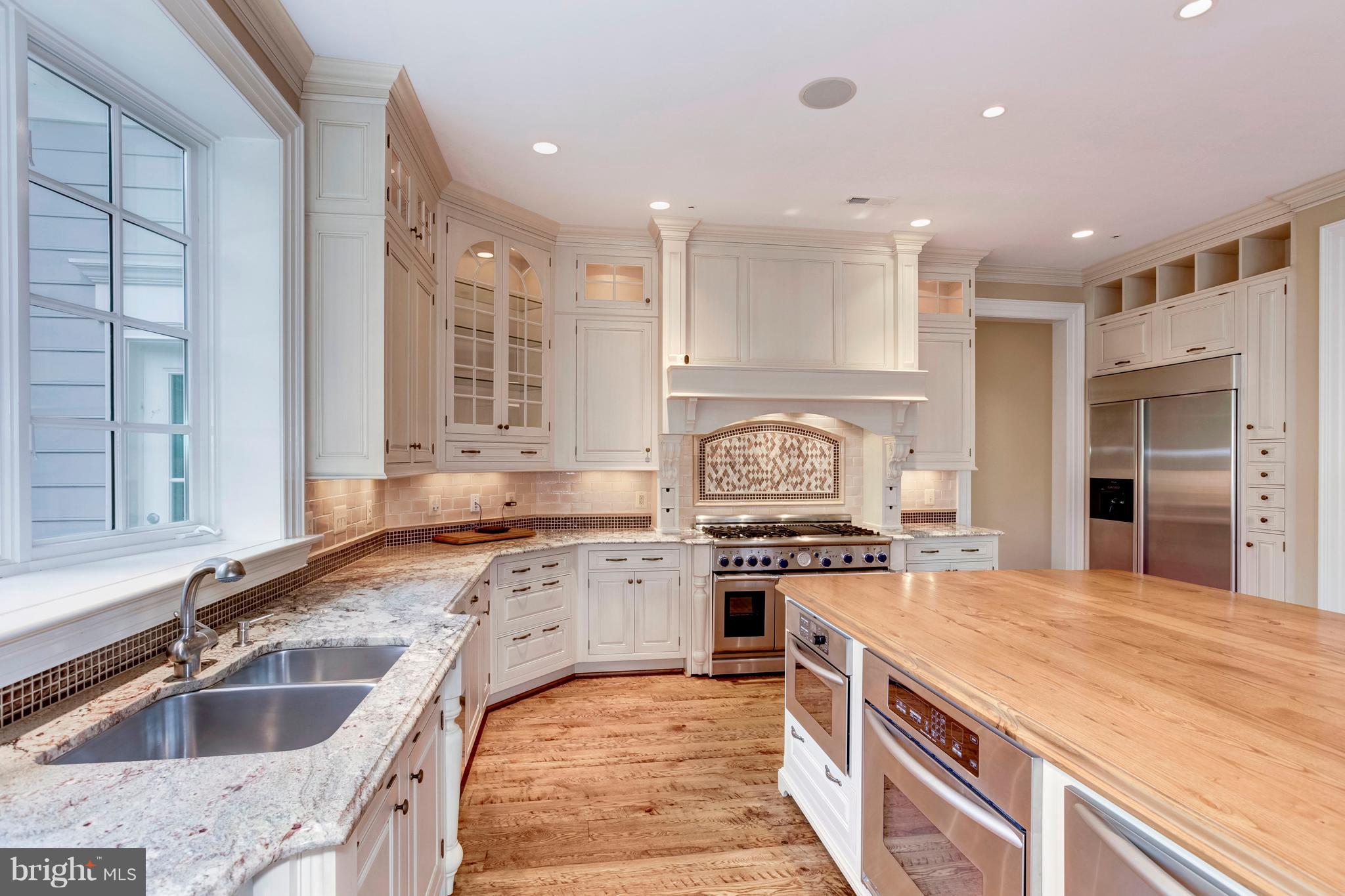 9809 Newhall Road Potomac, MD 20854 - Photo 8 of 37 a kitchen with a stove sink and cabinets