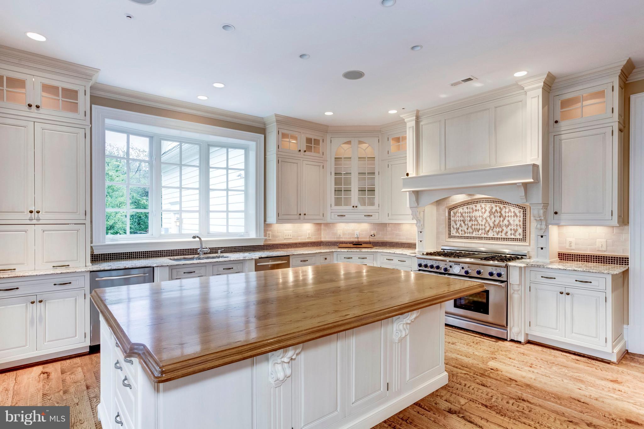 9809 Newhall Road Potomac, MD 20854 - Photo 9 of 37 a kitchen with a stove a sink and a refrigerator