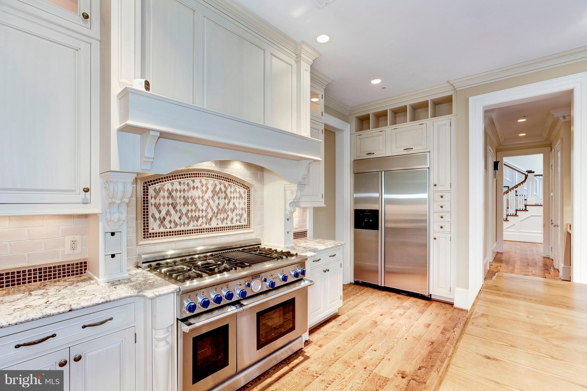 9809 Newhall Road Potomac, MD 20854 - Photo 10 of 37 a kitchen with stainless steel appliances granite countertop a stove and a refrigerator