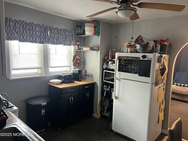 a kitchen with refrigerator and window