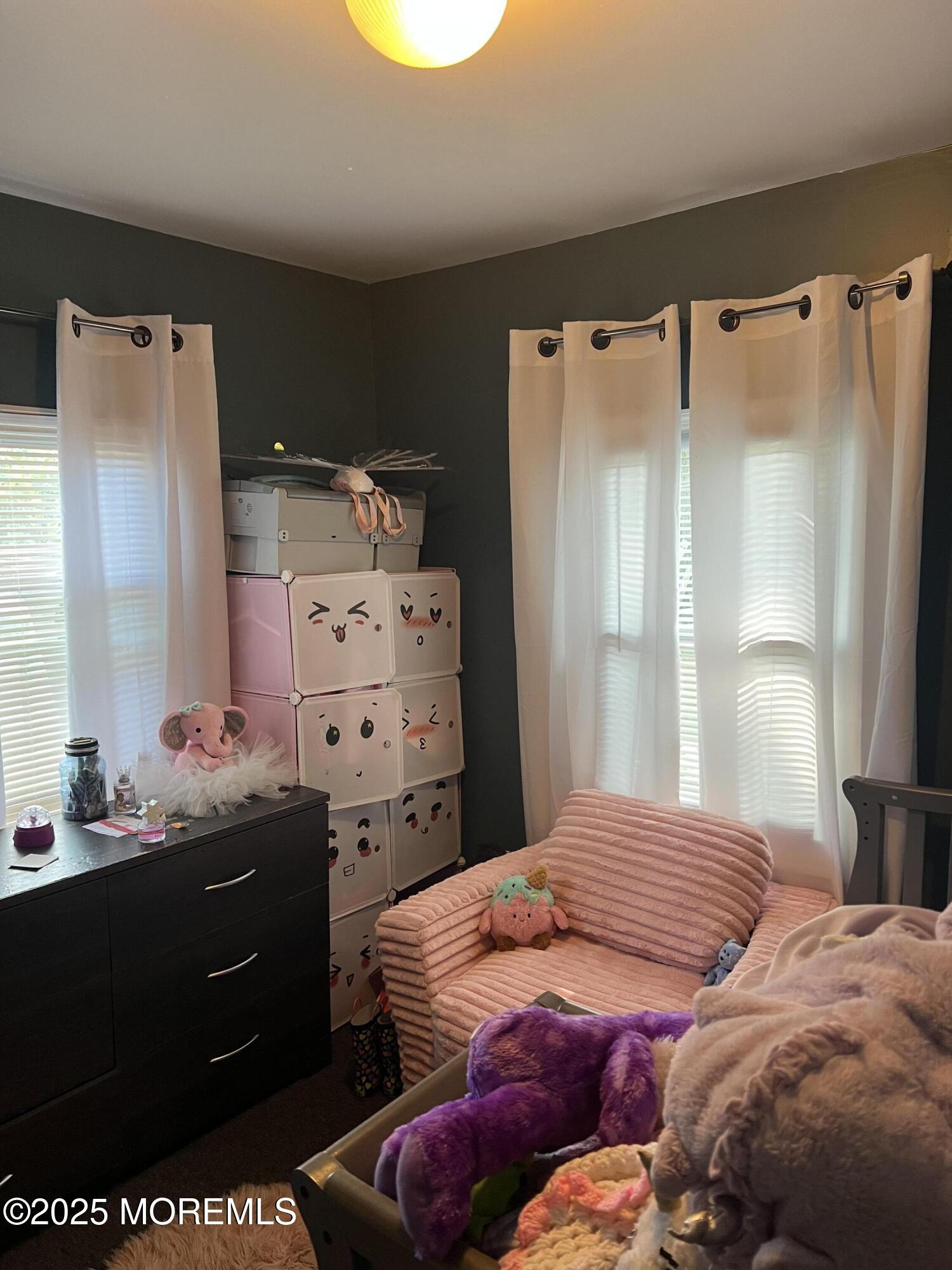 126 Leonard Avenue Neptune, NJ 07753 - Photo 19 of 27 a bedroom with a bed and a dresser