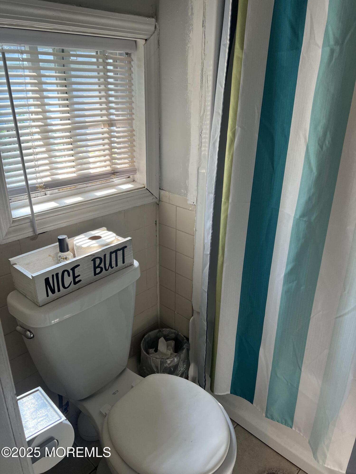 126 Leonard Avenue Neptune, NJ 07753 - Photo 21 of 27 a bathroom with a toilet a sink and a window