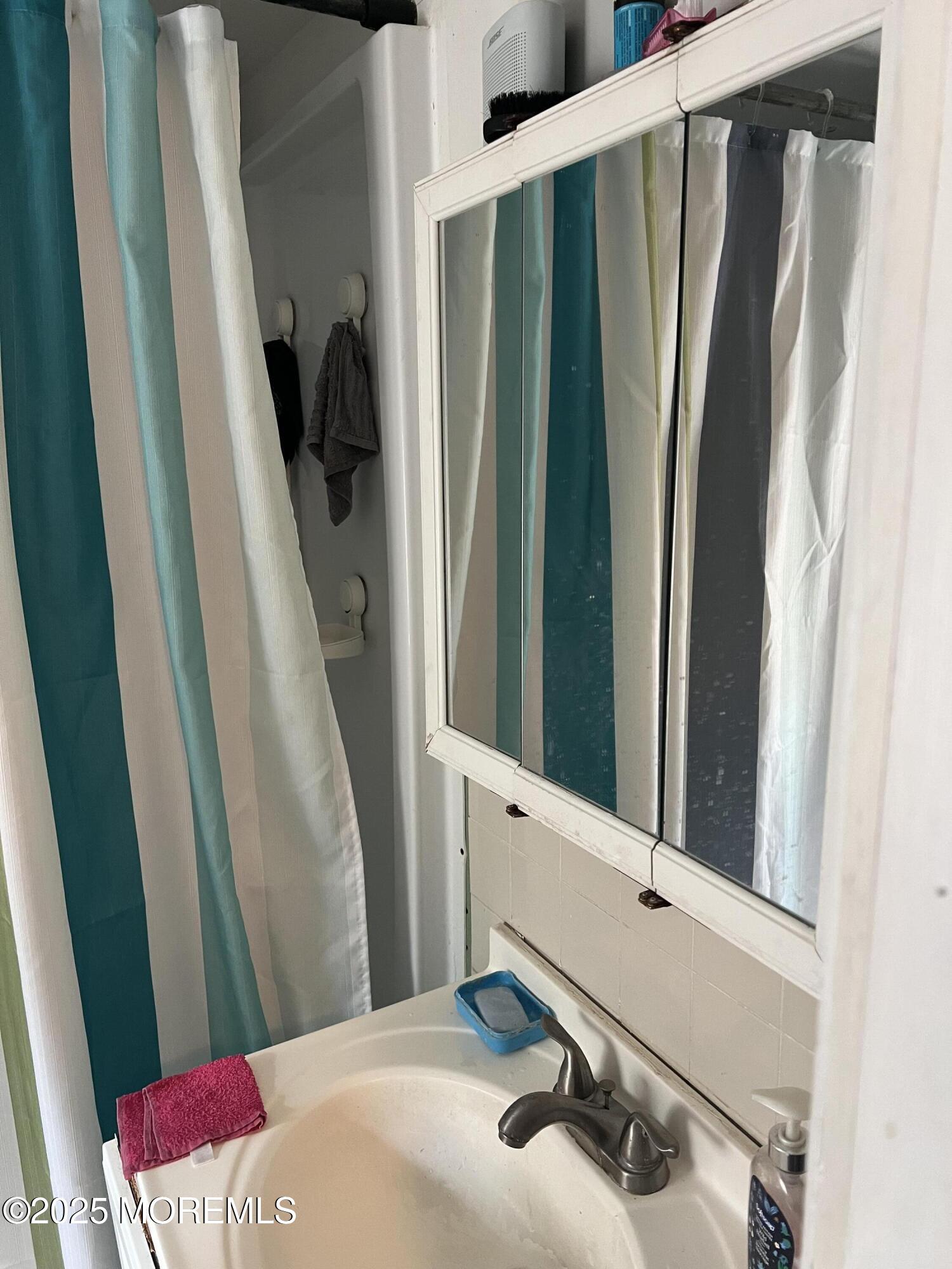 126 Leonard Avenue Neptune, NJ 07753 - Photo 22 of 27 a bathroom with a sink and a mirror