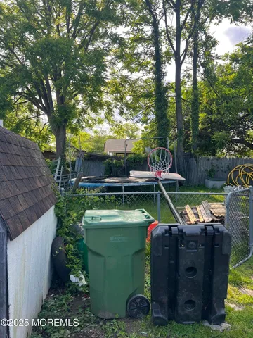 a view of a backyard with chairs and a fire pit