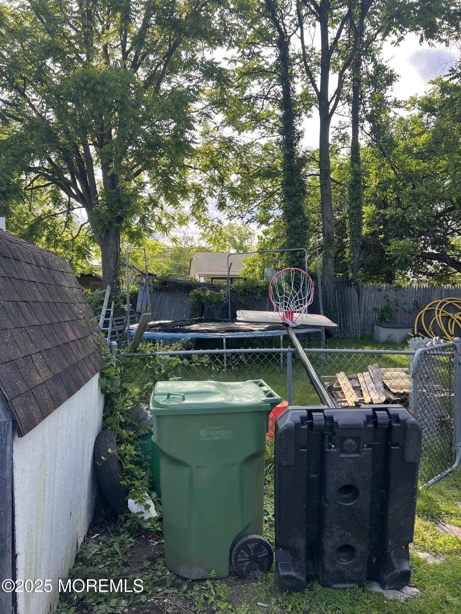 126 Leonard Avenue Neptune, NJ 07753 - Photo 26 of 27 a view of a backyard with chairs and a fire pit
