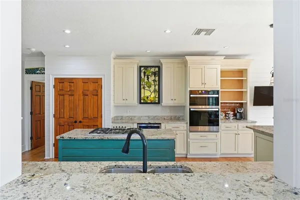 a bathroom with a granite countertop tub and a window