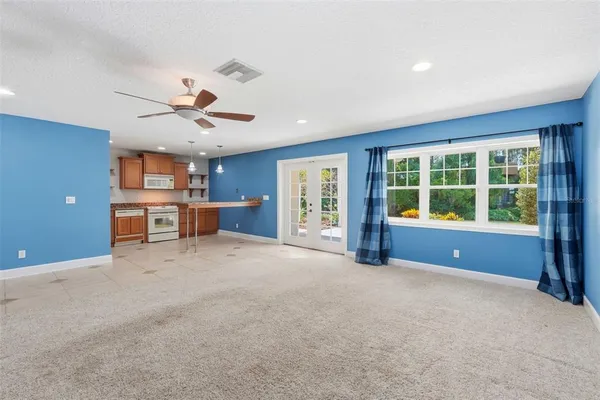 a view of an empty room with a flat screen tv and a window