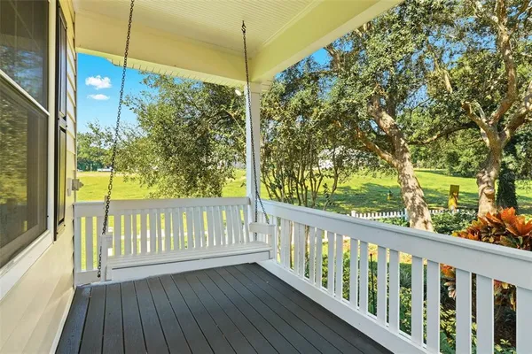 a view of an entryway with wooden floor and a ceiling fan