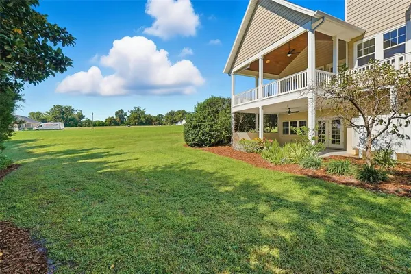 an aerial view of residential house with outdoor space and trees all around