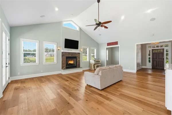 a living room with furniture fireplace and flat screen tv