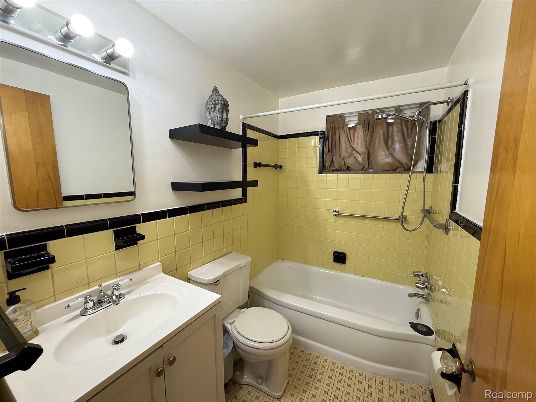 11012 Middlebelt Road Livonia, MI 48150 - Photo 7 of 14 Bathroom featuring a porcelain vanity with integrated sink, chrome faucet, and under-vanity storage