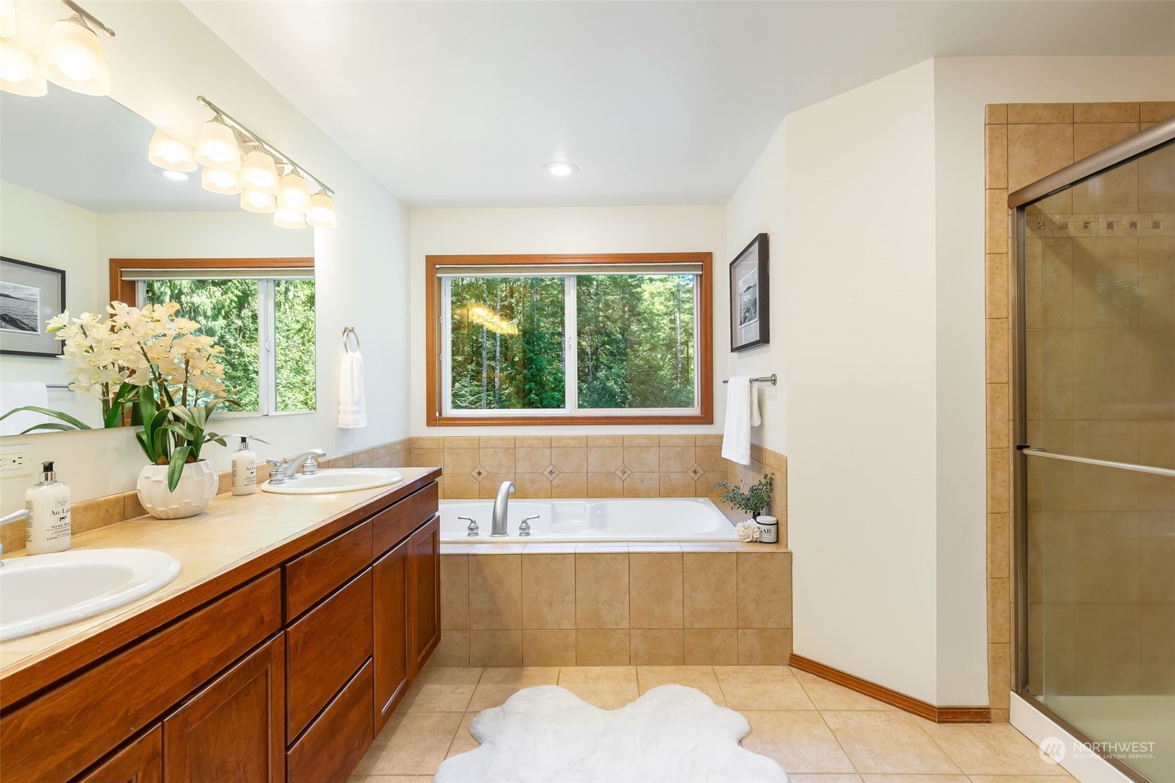 11227 Upper Preston Road Southeast Issaquah, WA 98027 - Photo 12 of 27 a bathroom with a tub sink and mirror