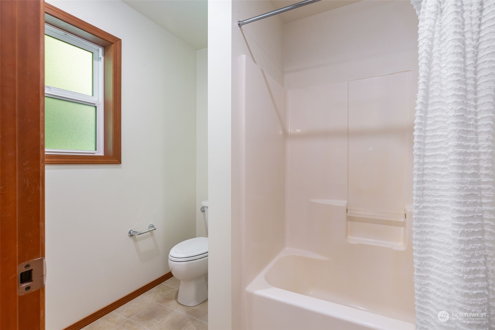 11227 Upper Preston Road Southeast Issaquah, WA 98027 - Photo 17 of 27 a bathroom with a bathtub and a toilet