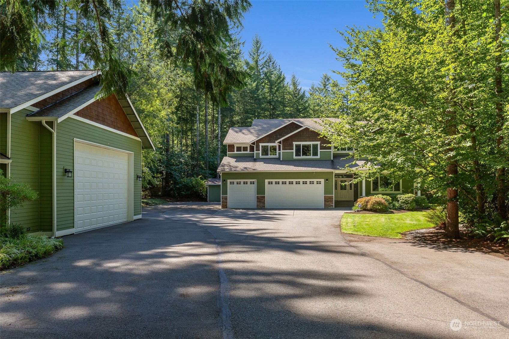 11227 Upper Preston Road Southeast Issaquah, WA 98027 - Photo 2 of 27 a front view of a house with a garden and trees