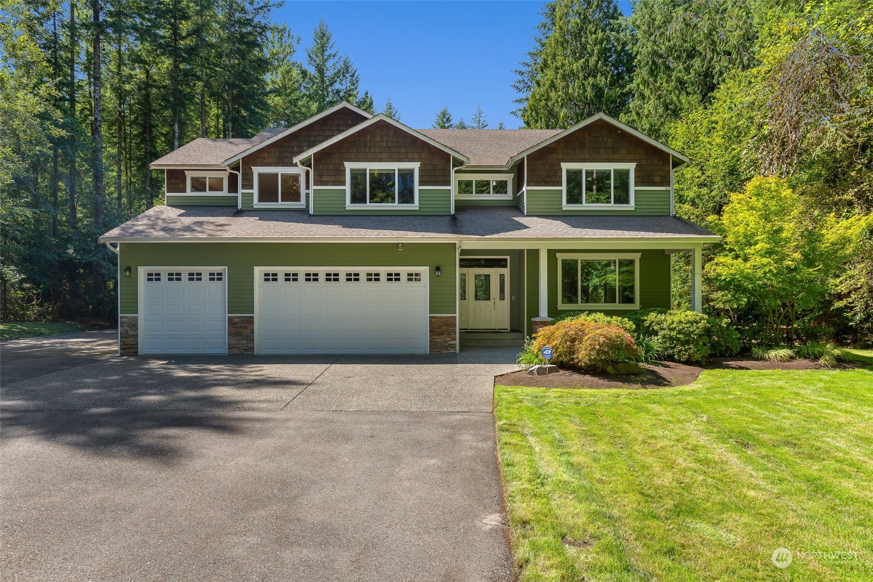 11227 Upper Preston Road Southeast Issaquah, WA 98027 - Photo 3 of 27 a front view of a house with a garden and yard